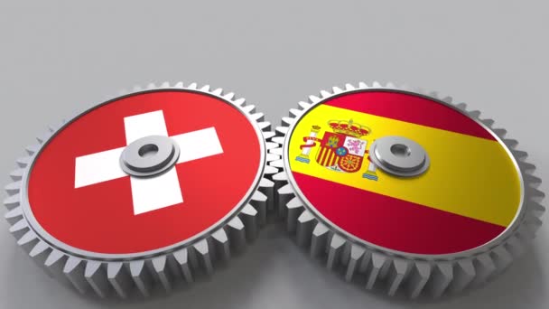 Flaggor av Schweiz och Spanien på Meshning gears. Internationellt samarbete konceptuella animation — Stockvideo