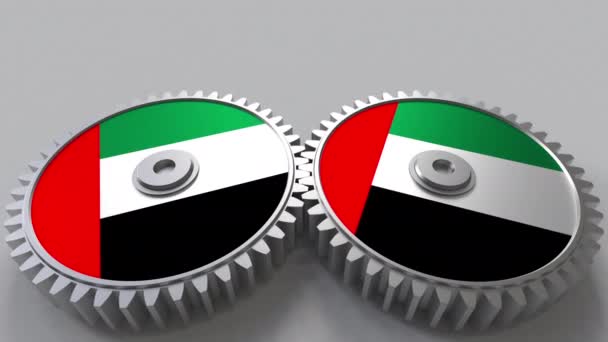 Proyecto nacional. Banderas de los Emiratos Árabes Unidos Emiratos Árabes Unidos sobre ruedas dentadas en movimiento. Animación conceptual — Vídeo de stock
