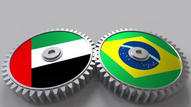 Flaggor för Uae och Brasilien på Meshning gears. Internationellt samarbete konceptuella animation — Stockvideo