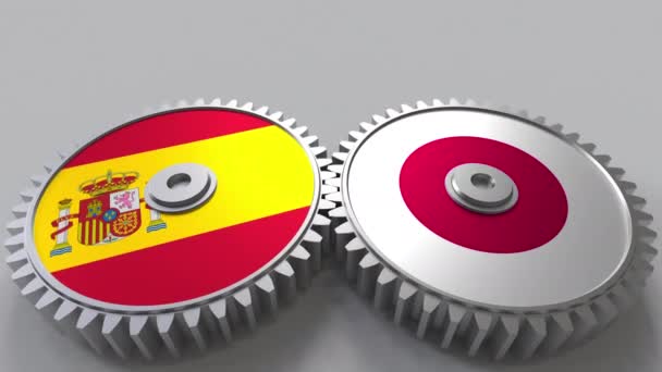 Bandiere della Spagna e del Giappone su ingranaggi a maglie. Cooperazione internazionale animazione concettuale — Video Stock