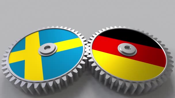 Bandeiras da Suécia e da Alemanha em engrenagens de malha. Cooperação internacional animação conceitual — Vídeo de Stock