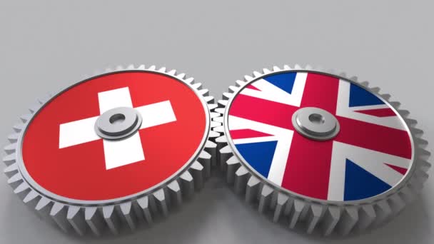 Flaggor i Schweiz och Storbritannien på Meshning gears. Internationellt samarbete konceptuella animation — Stockvideo