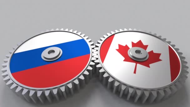 Banderas de Rusia y Canadá en engranajes de malla. Cooperación internacional animación conceptual — Vídeos de Stock