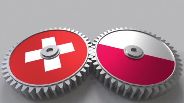 Flaggor av Schweiz och Polen på Meshning gears. Internationellt samarbete konceptuella animation — Stockvideo