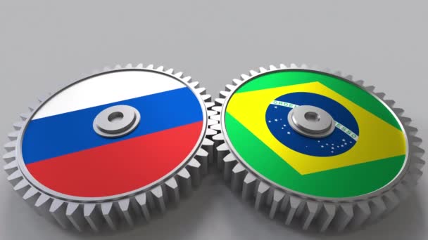Flags of Russia and Brazil on meshing gears. International cooperation conceptual animation — Stock Video