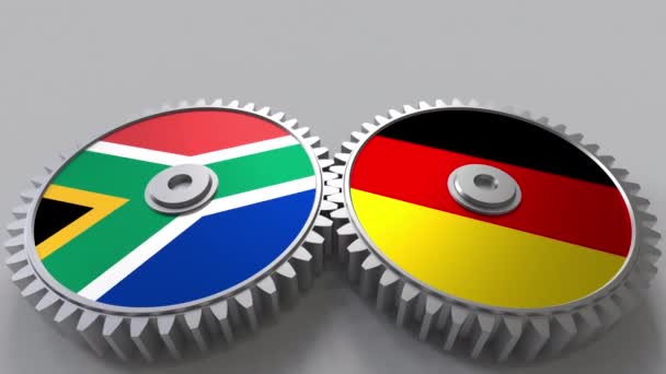 Banderas de Sudáfrica y Alemania en engranajes de malla. Cooperación internacional animación conceptual — Vídeo de stock