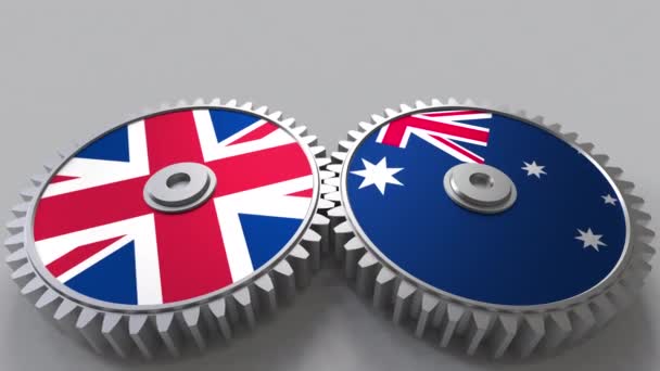 Flaggor av Storbritannien och Australien på Meshning gears. Internationellt samarbete konceptuella animation — Stockvideo