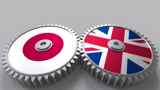 Прапори Японії і Сполучене Королівство на сітки gears. Міжнародне співробітництво концептуальні анімації — стокове відео