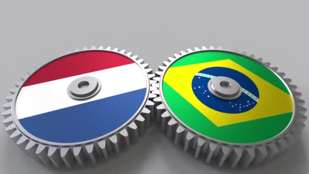 Drapeaux des Pays-Bas et du Brésil sur les engrenages. Coopération internationale animation conceptuelle — Video