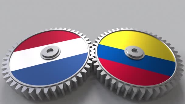 Σημαίες της Ολλανδίας και της Κολομβίας σχετικά με συγκερασμό γρανάζια. Εννοιολογική animation διεθνούς συνεργασίας — Αρχείο Βίντεο