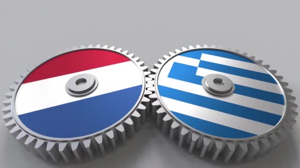 Flags of the Netherlands and Greece on meshing gears. International cooperation conceptual animation — Stock Video