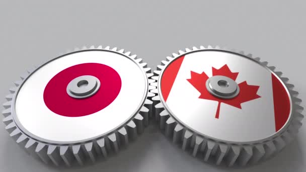 Flaggor i Japan och Kanada på Meshning gears. Internationellt samarbete konceptuella animation — Stockvideo