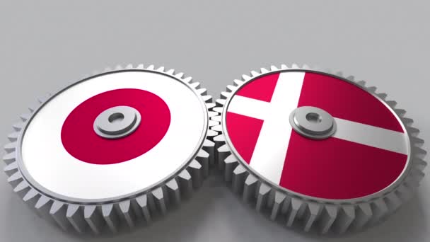 Flaggor av Japan och Danmark på Meshning gears. Internationellt samarbete konceptuella animation — Stockvideo