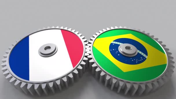 Flags of France and Brazil on meshing gears. International cooperation conceptual animation — Stock Video