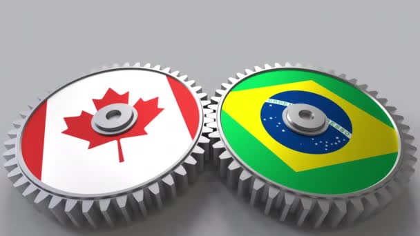 Flags of Canada and Brazil on meshing gears. International cooperation conceptual animation — Stock Video