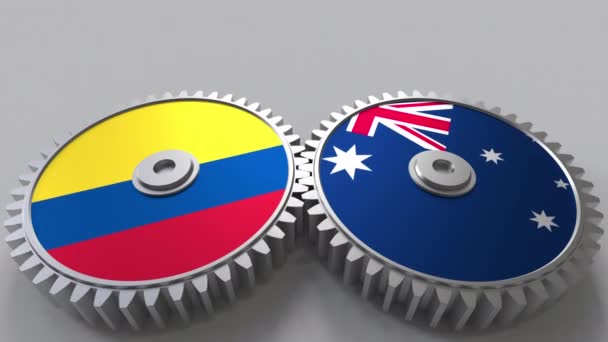 Flags of Colombia and Australia on meshing gears. International cooperation conceptual animation — Stock Video