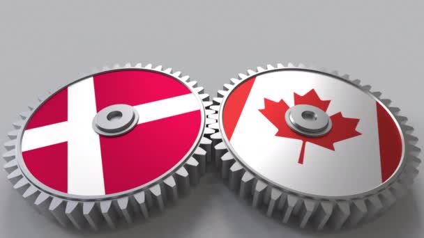 丹麦和加拿大在啮合齿轮上的旗帜。国际合作概念动画 — 图库视频影像