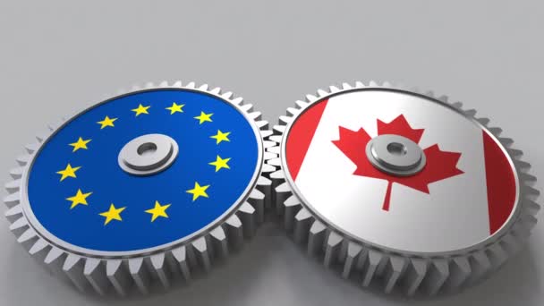 Flaggor av Europeiska unionen och Kanada på Meshning gears. Internationellt samarbete konceptuella animation — Stockvideo