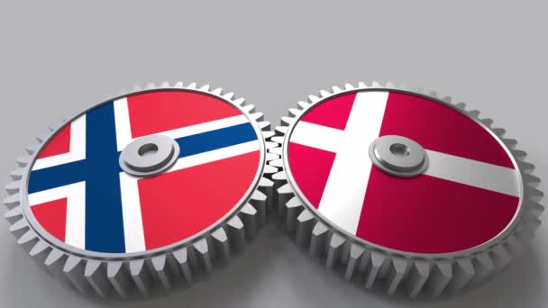 Zászlók, Norvégia és Dánia a kerítésfonatok fogaskerekek. Nemzetközi együttműködés fogalmi animáció — Stock videók
