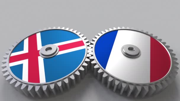 Lijst van vlaggen van IJsland en Frankrijk op het weven van de versnellingen. Internationale samenwerking conceptuele animatie — Stockvideo