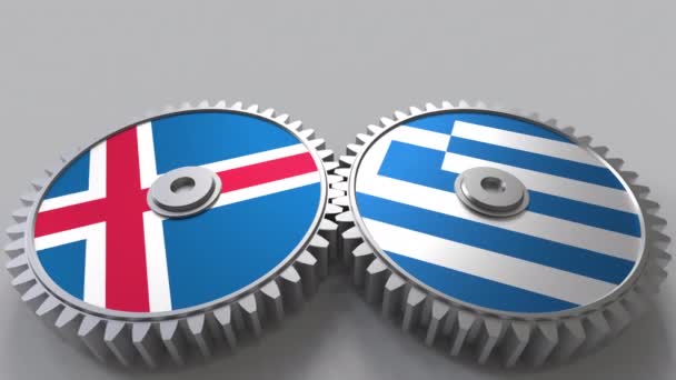冰岛和希腊在啮合齿轮上的旗帜。国际合作概念动画 — 图库视频影像