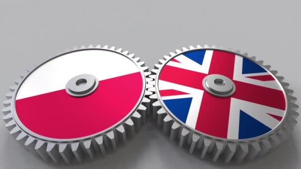 Flags of Poland and The United Kingdom on meshing gears. International cooperation conceptual animation — Stock Video