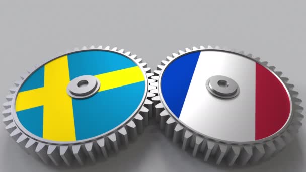 Flaggor för Sverige och Frankrike på Meshning gears. Internationellt samarbete konceptuella animation — Stockvideo