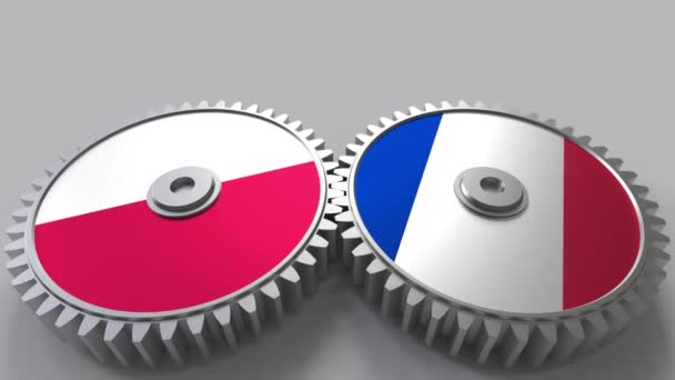 Banderas de Polonia y Francia en engranajes de malla. Cooperación internacional animación conceptual — Vídeo de stock