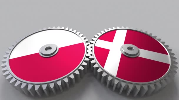 Flaggor av Polen och Danmark på Meshning gears. Internationellt samarbete konceptuella animation — Stockvideo