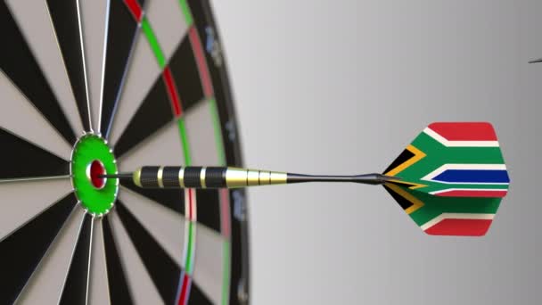 Flags of Canada and South Africa on darts hitting bullseye of the target. International cooperation or competition conceptual animation — Stock Video