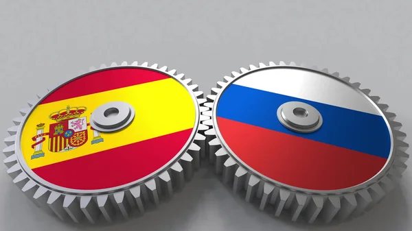西班牙和俄罗斯在啮合齿轮上的旗帜。国际合作概念3d 渲染 — 图库照片