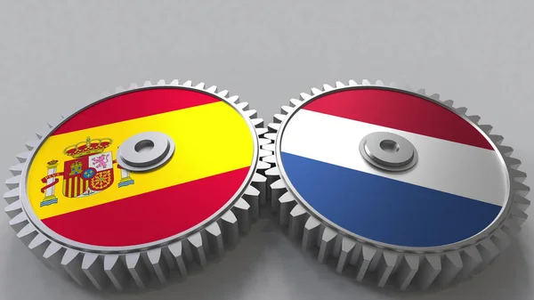 Bandeiras de Espanha e Países Baixos em engrenagens de malha. Cooperação internacional conceitual renderização 3D — Fotografia de Stock