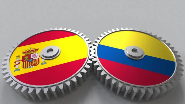 Bandeiras de Espanha e Colômbia em engrenagens de malha. Cooperação internacional conceitual renderização 3D — Fotografia de Stock