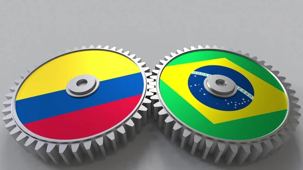Bandiere della Colombia e del Brasile su ingranaggi a maglie. Cooperazione internazionale concettuale rendering 3D — Foto Stock