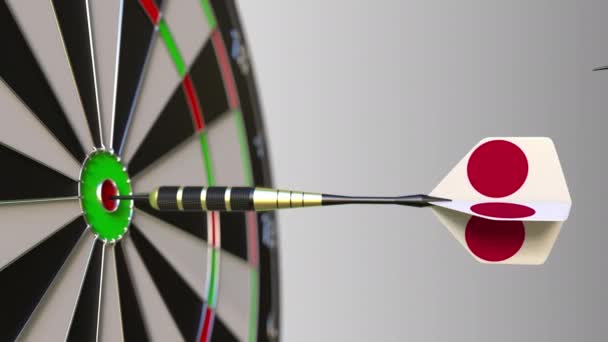 Flags of South Korea and Japan on darts hitting bullseye of the target. International cooperation or competition conceptual animation — Stock Video