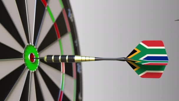 Flags of the UAE and South Africa on darts hitting bullseye of the target. International cooperation or competition conceptual animation — Stock Video