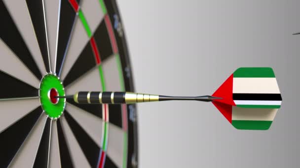 Flags of Japan and the UAE on darts hitting bullseye of the target. International cooperation or competition conceptual animation — Stock Video