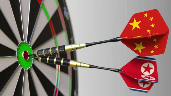 Kína és Észak-Korea a darts ütő telitalálat a cél. Nemzetközi együttműködés, illetve a verseny fogalmi 3d-leképezés — Stock Fotó
