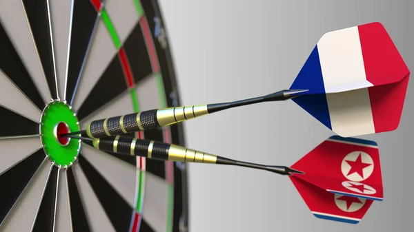 Franciaország és Észak-Korea a darts ütő telitalálat a cél. Nemzetközi együttműködés, illetve a verseny fogalmi 3d-leképezés — Stock Fotó