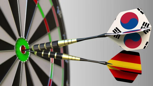 Güney Kore ve Almanya bayrakları Dart hedef bullseye isabet üzerinde. Uluslararası işbirliği ya da rekabet kavramsal 3d render — Stok fotoğraf