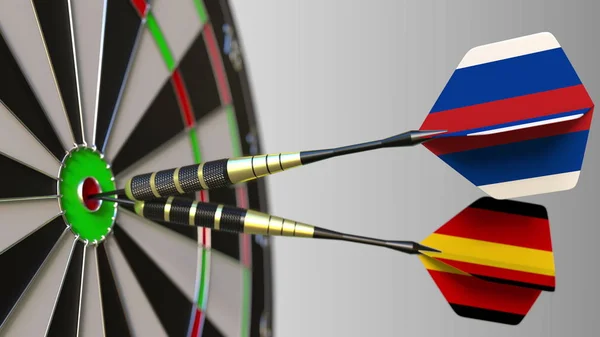 Flags of Russia and Germany on darts hitting bullseye of the target. International cooperation or competition conceptual 3D rendering — Stock Photo, Image