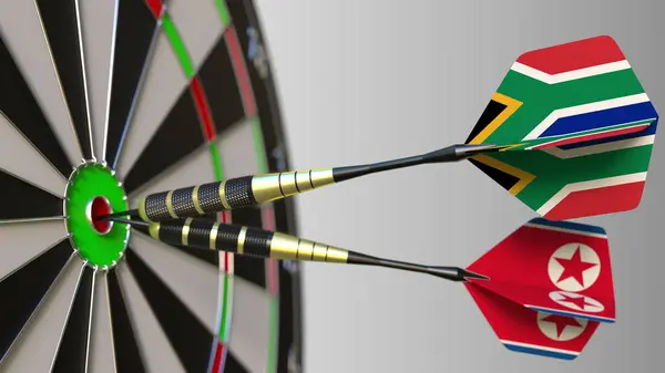 Zászlók, Dél-Afrika és Észak-Korea a darts, ütő a cél telitalálat. Nemzetközi együttműködés, illetve a verseny fogalmi 3d-leképezés — Stock Fotó