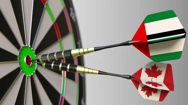 Birleşik Arap Emirlikleri ve Kanada bayrakları hedef isabet bullseye Dart. Uluslararası işbirliği ya da rekabet kavramsal 3d render — Stok fotoğraf