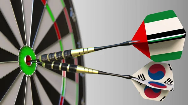 Birleşik Arap Emirlikleri ve Kore bayrakları hedef isabet bullseye Dart. Uluslararası işbirliği ya da rekabet kavramsal 3d render — Stok fotoğraf