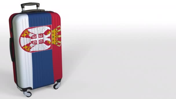 Travelers suitcase featuring flag of Serbia. Serbian tourism conceptual animation, blank space for caption — Stock Video