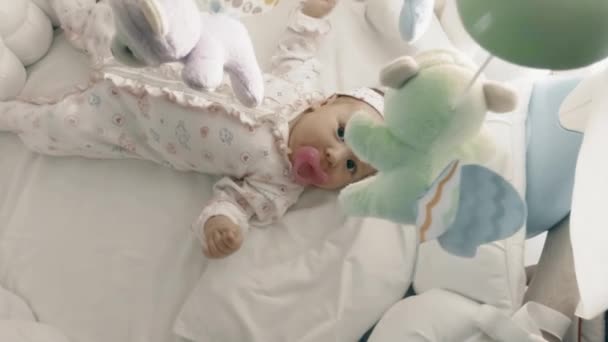 Playful newborn baby girl in her cot — Stock Video