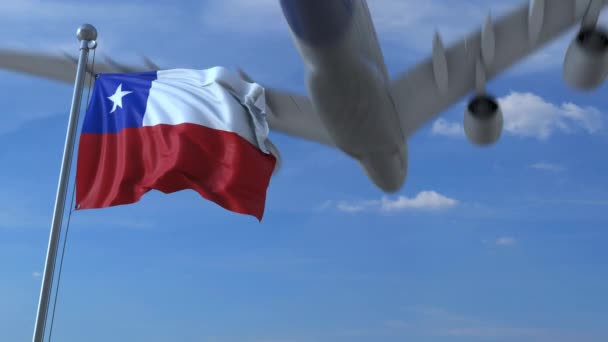 Commercial airplane flying above waving flag of Chile. Chilean emigration or tourism related animation — Stock Video