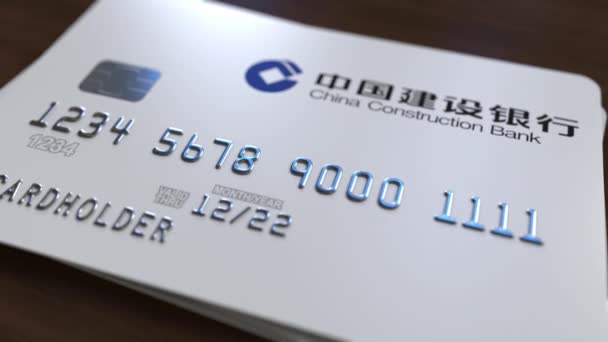 Plastic card with logo of China Construction Bank. Editorial conceptual 3D animation — Stock Video