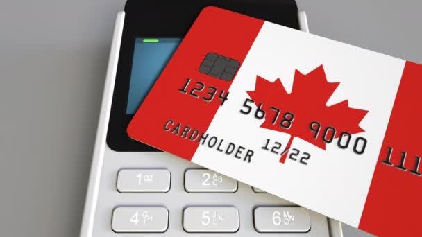 Payment or POS terminal with credit card featuring flag of Canada. Canadian retail commerce or banking system conceptual animation — Stock Video