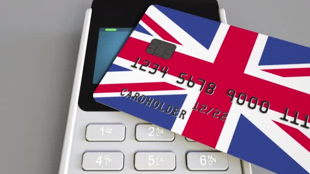 Payment or POS terminal with credit card featuring flag of Great Britain. British retail commerce or banking system conceptual animation — Stock Video